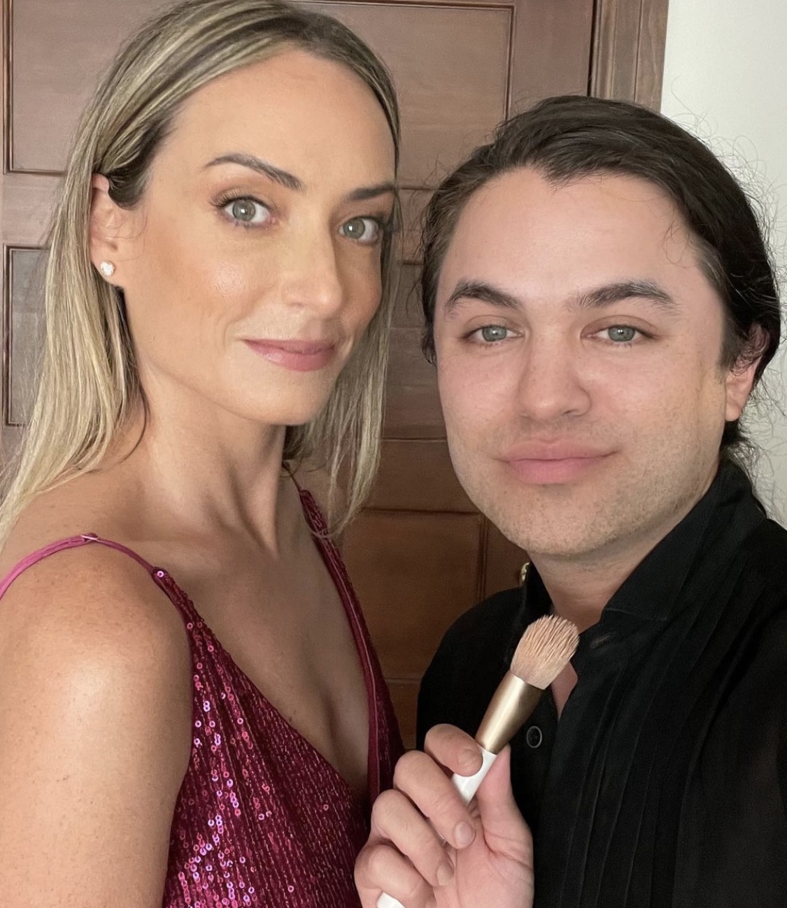 Carwin Brice with client holding makeup brush