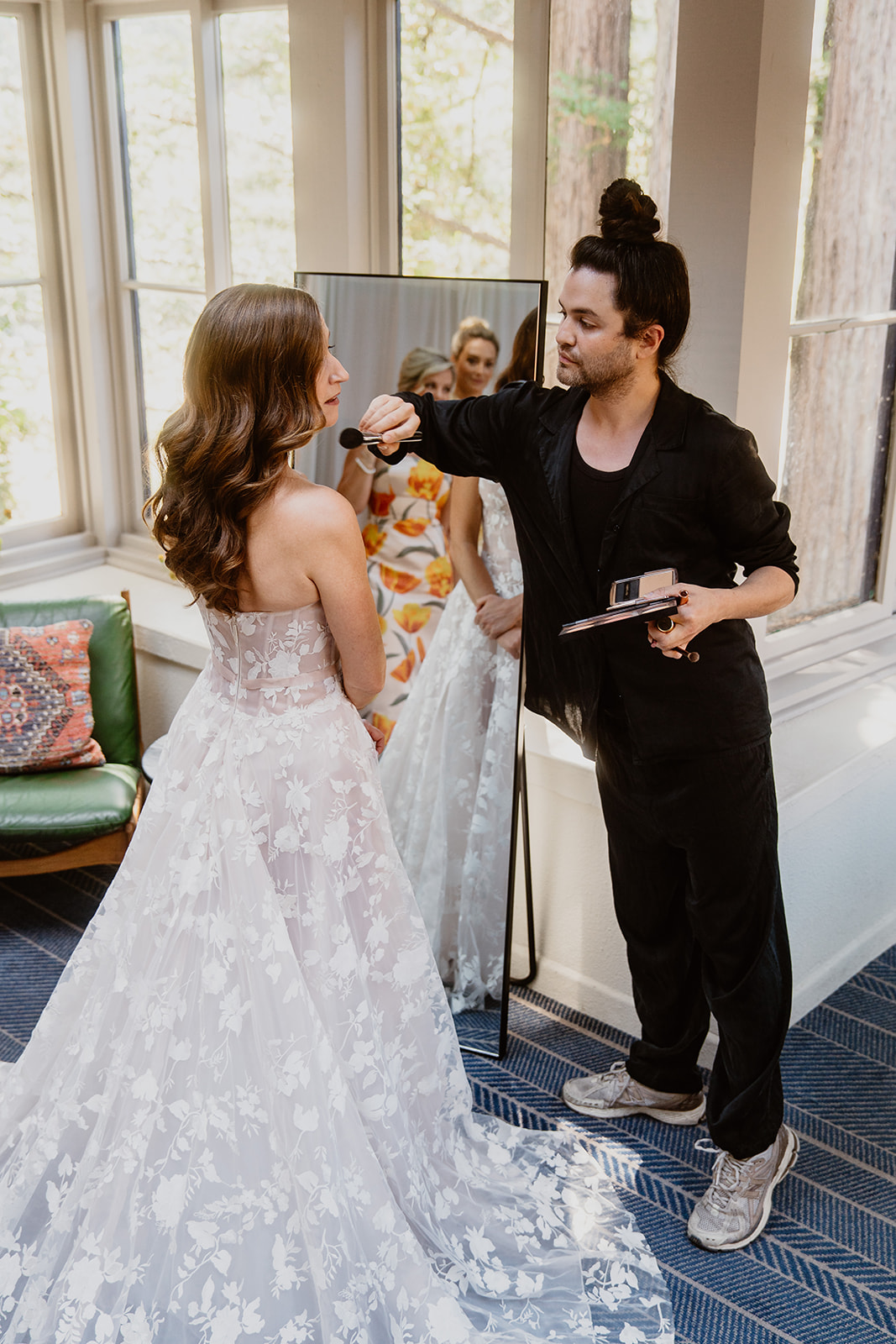 Carwin Brice applying makeup to bride in floral gown